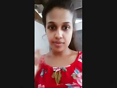 A Sri Lankan woman windowdressing her breasts